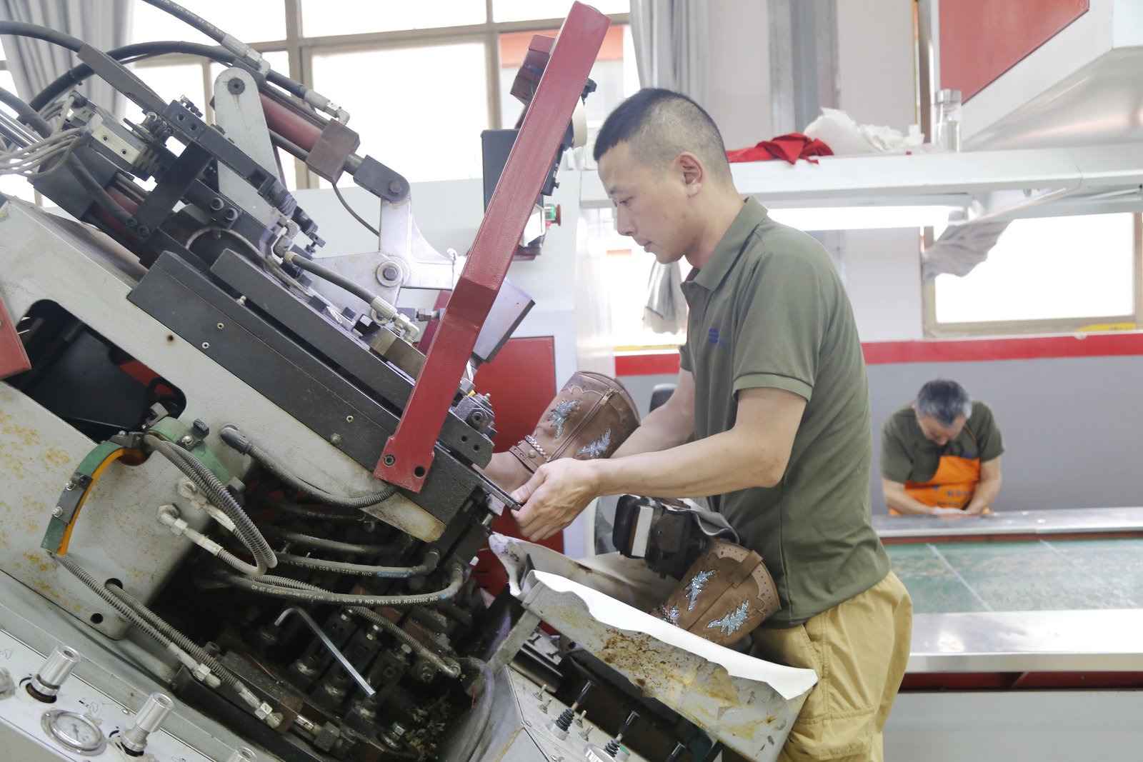 Craftsperson finishing a footwear sample