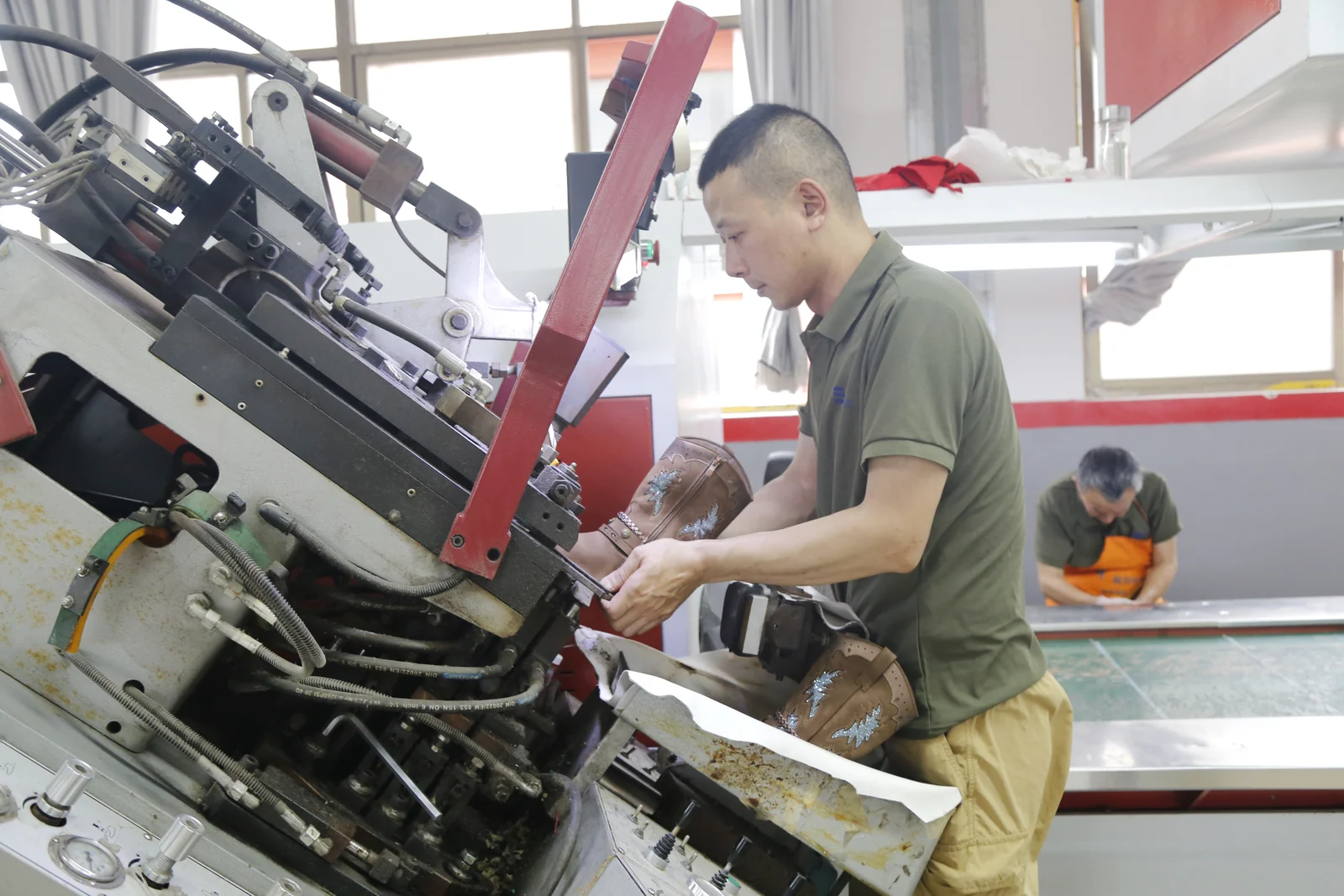 Craftsperson finishing a footwear sample